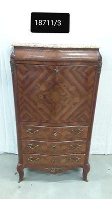 a wooden chest of drawers with a marble top