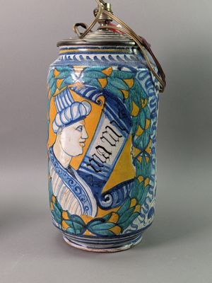 a blue and yellow canister with a picture of a woman on it