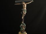 a statue of jesus on the cross on a black background