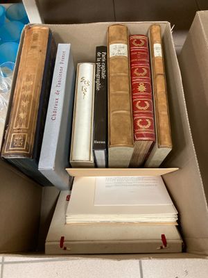 a box full of books on a tiled floor