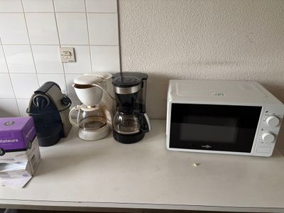 a microwave and coffee maker on a counter in a kitchen