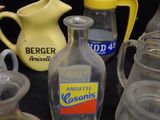 many different types of glass bottles on the table