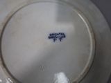 a white plate with a blue and white design on it