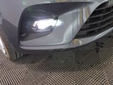 a close up of a car ' s headlight and front bumper
