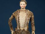an antique doll of a man in a suit and tie