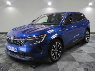 a blue suv parked on a checkered floor in a garage