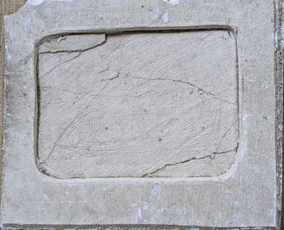 a stone plaque with a picture of a fish on it