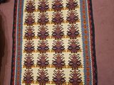 an image of a rug on the floor next to a pair of shoes