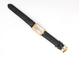 a gold and black watch with a black leather strap
