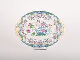 a plate with a floral design on it on a stand