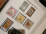 a shadow of a person standing in front of a book with stamps on it