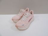 a pair of pink sneakers with white laces on a white surface