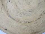 a brown bowl with a black rim sitting on a table