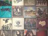 a picture of a wall full of albums and cds