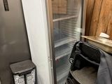 an image of a refrigerator and a chair in a room