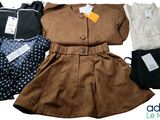 a group of clothing that includes a dress, jacket, and pants