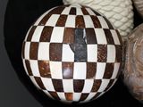 a black bowl filled with different types of decorative objects