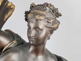 a bronze statue of a woman holding a book