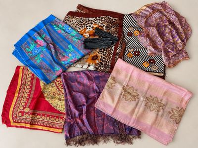 several different types of scarves laid out on a white surface