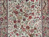 an antique persian rug with birds and flowers on a white ground