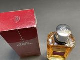 perfume bottle next to a box of perfume on a table