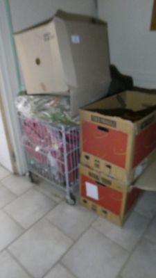 many boxes stacked on a cart in a room