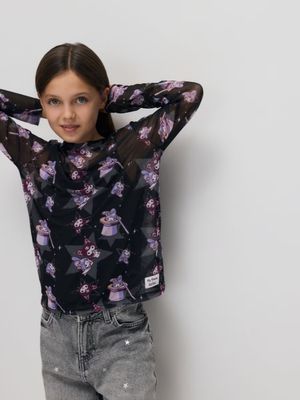 the young girl is posing against a wall with her hands on her head