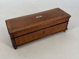 an old wooden box sitting on top of a white surface