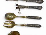 five different types of silverware on a white surface
