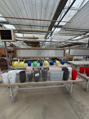 many different colored vases on a table in a warehouse