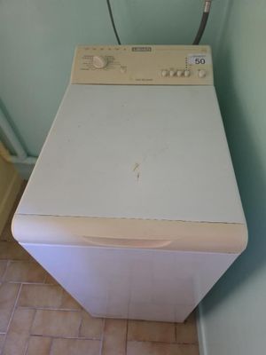 a white washer and dryer in a small room
