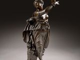 an image of a bronze statue of a woman holding a bird
