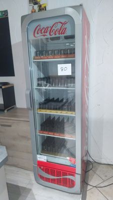 a coca cola cooler that is on display in a room