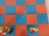 a picture of a checkered board with a bunch of fruit on it