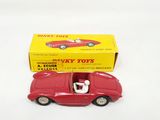 a red toy car that is sitting in front of a yellow box