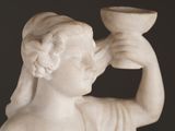 a statue of a woman holding a bowl in her hand