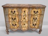 une vieille commode dont les tiroirs sont ornés de motifs floraux
