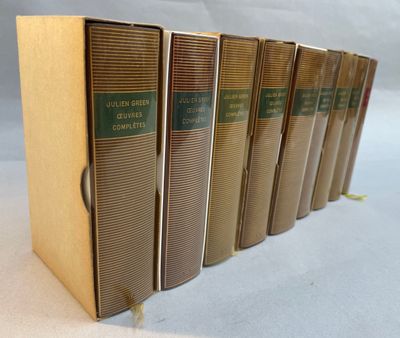 six books are lined up in a row on a white surface