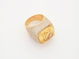 a gold ring with a yellow stone surrounded by white diamonds