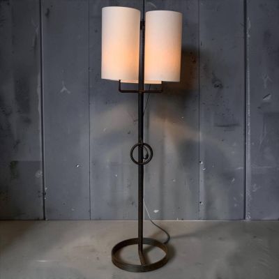 a pair of lamps sitting on top of a table next to a wall