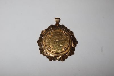 a close up of a gold coin on a white surface