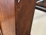a wooden cabinet with a door open in a room