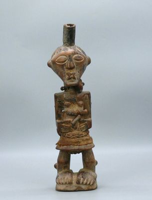 an old wooden figurine of a man holding a baby in his arms