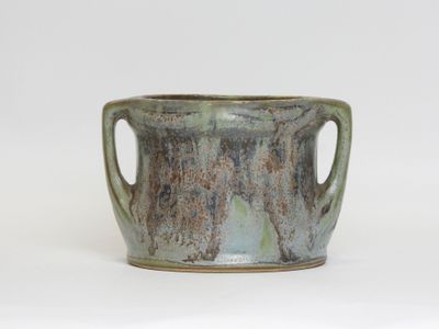 a close up of a cup on a white surface
