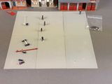 a small model of a building with a lot of people on it