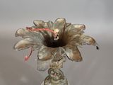 a small glass vase with a flower inside of it