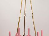 a chandelier with pink candles hanging from it