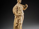 a statue of a woman holding a flower in her hand