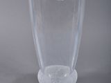 a clear glass vase with a green label on it