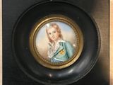 an antique miniature portrait of a woman in a blue dress